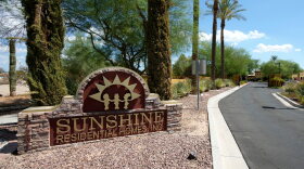 Brick sign that's yellow and red reads Sunshine Residential Homes, Inc. in driveway