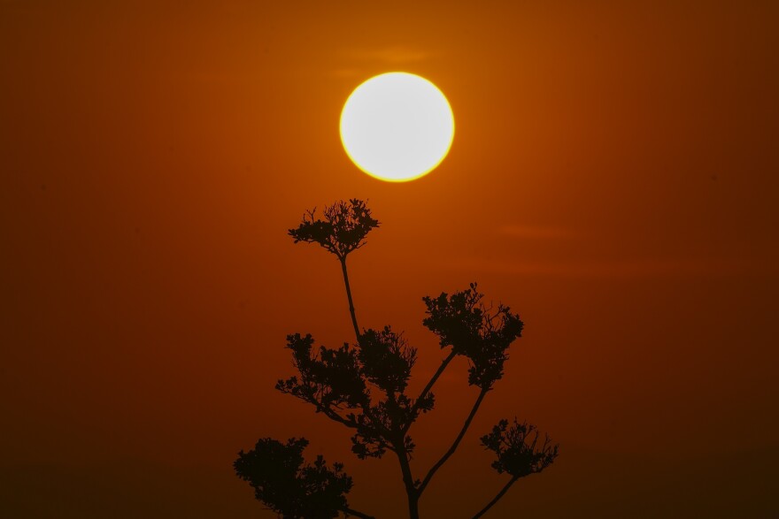 The sun rises amid high temperatures.
