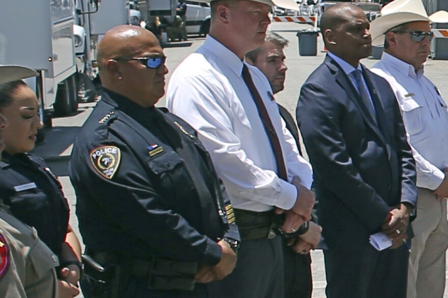 Uvalde School Police Chief Pete Arredondo (second from left) stands during a news conference outside of the Robb Elementary School in Uvalde, Texas, on May 26. He resigned as a member of the Uvalde City Council and remains on administrative leave for his police role.