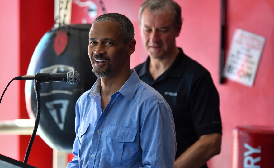 The Rev. Samuel Washington, founder of Pulpit Boxing, speaks at the Pittston gym as U.S. Rep. Matt Cartwright listens.