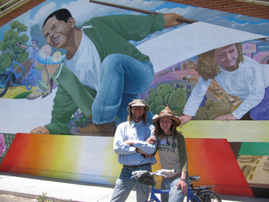 Artists R.E. Wall and Maggie Dewar stand in front of the Miller Valley Elementary School mural.