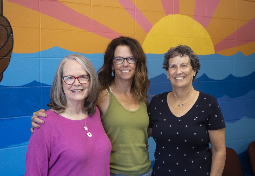 Three child care advocates pose for a picture.