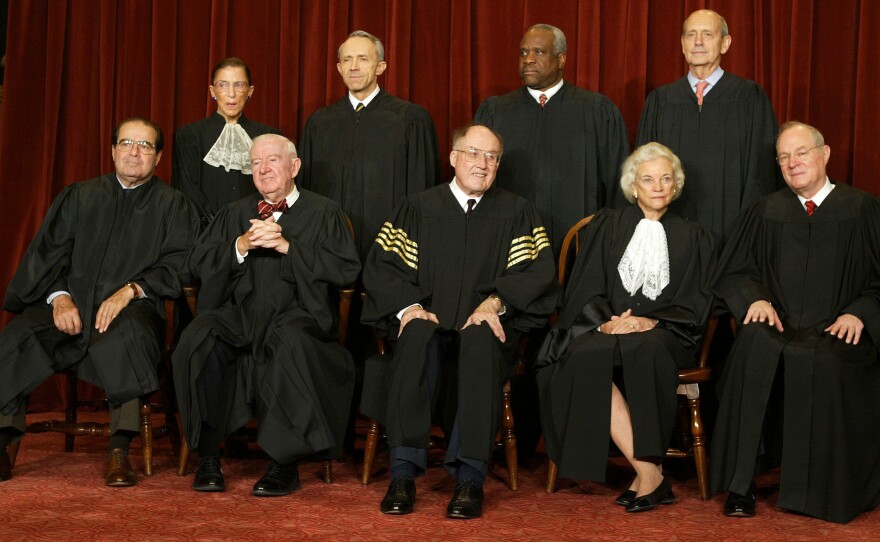 O'Connor and Rehnquist are pictured with the other Supreme Court justices for a photo in 2003.