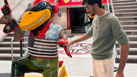 Daniyal Shahbaz, a native of Pakistan, stands next to the Iowa State University mascot inside the school’s Memorial Union building during fall freshman orientation in 2024.