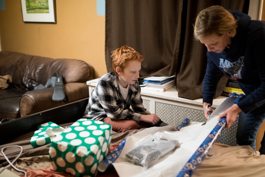 Liam and his mother Heather Leupker wrap gifts. Liam decided to get brain surgery to treat dystonia after his father had the procedure.