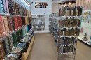 Rows and rows of beads and arts materials fill a store