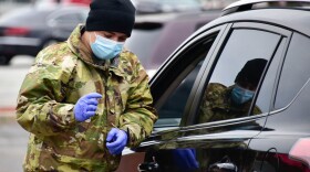 A National Guard member helps at a drive thru vaccination clinic in South Bend.