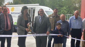 Bettendorf Public Library Director Jillian Aschliman cuts the ribbon (with Mayor Bob Gallagher) on the library's new outreach vehicle, Wednesday, Sept. 30, 2026.