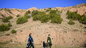 Dianne DeLeon, left, and her mother Victoria Trujillo walk along Juan De Medina Rd on their way to the El Santuario De Chimayo in Northern New Mexico on Good Friday, April 18, 2025. Chimayo, N.M. (AP Photo/Roberto E. Rosales)