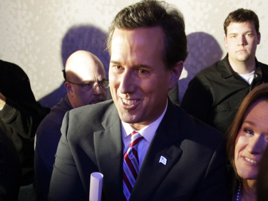 Former Pennsylvania Sen. Rick Santorum greets supporters after his caucus night rally in Johnston, Iowa, on Tuesday.