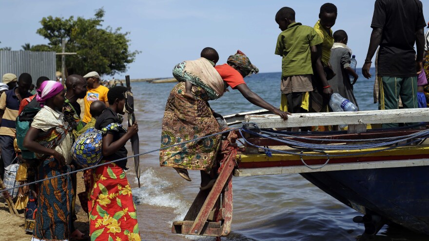 Refugees who fled Burundi's violence and political tension board a speedboat to reach a ship on Lake Tanganyika, Tanzania, on May 23. Some 100,000 refugees have fled Burundi for neighboring countries in recent months.