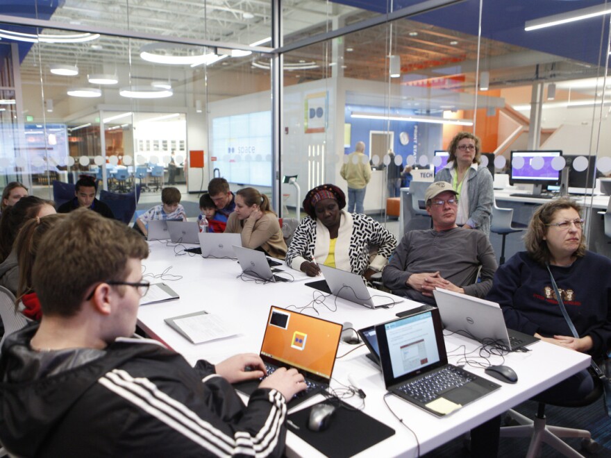 Students at Do Space learn to use a laser cutter during a crash course on how to design a key chain.