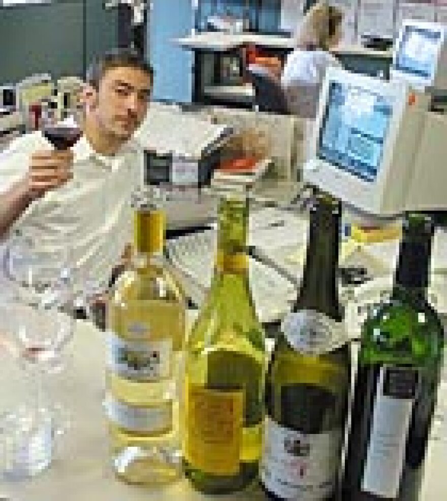 <i>All Things Considered</i>'s Ben Gilbert with the remains of the staff wine taste-testing experiment.