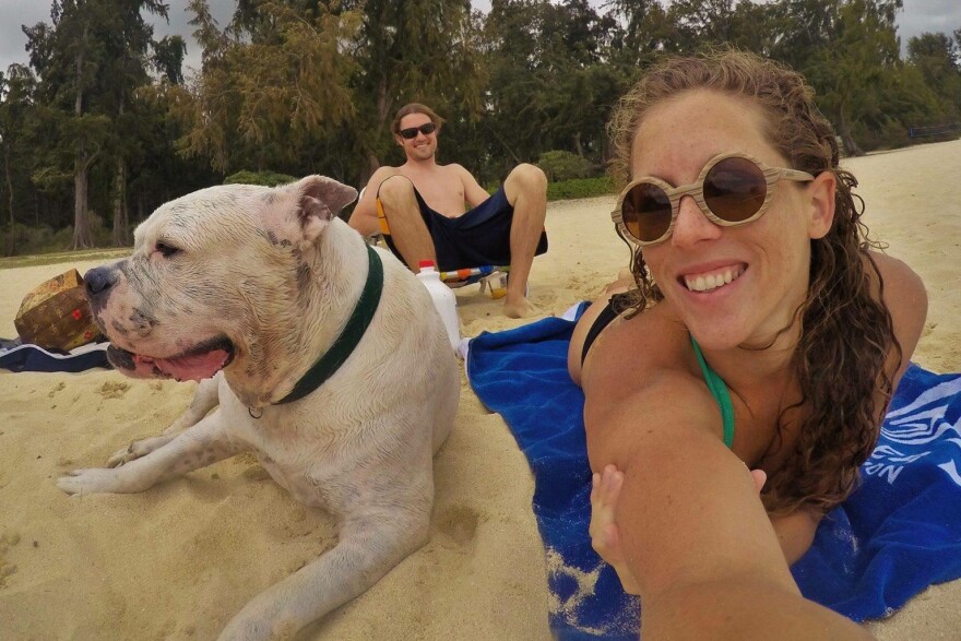 Mary Finley, Travis Sherman and Tonka at the beach. "I'm fearful of the world that we are making for ourselves," Travis said. "That's why I don't want to have children." (Courtesy Mary Finley)