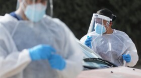 Frontline healthcare workers work at a drive-in COVID-19 testing site amid a surge of COVID-19 cases in El Paso on November 13, 2020. (Mario Tama/Getty Images)