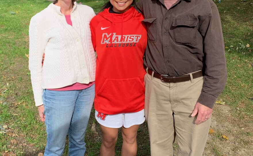 Emma LeMay with her parents, Lisa and John, in 2019.