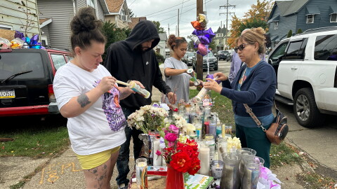 People gather at a memorial in Erie, Pa., Sunday, Oct. 11, 2026, outside the home where authorities say a gunman killed several people before killing himself on Oct. 9. 