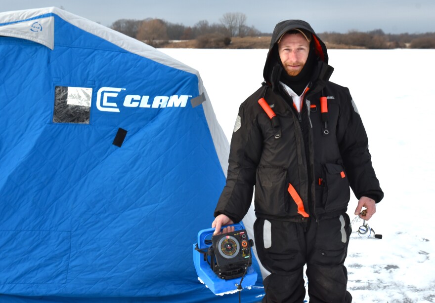 Mike Davis ice fishing at Watkins Lake State Park and County Preserve. The lake does not freeze over as often as it once did.