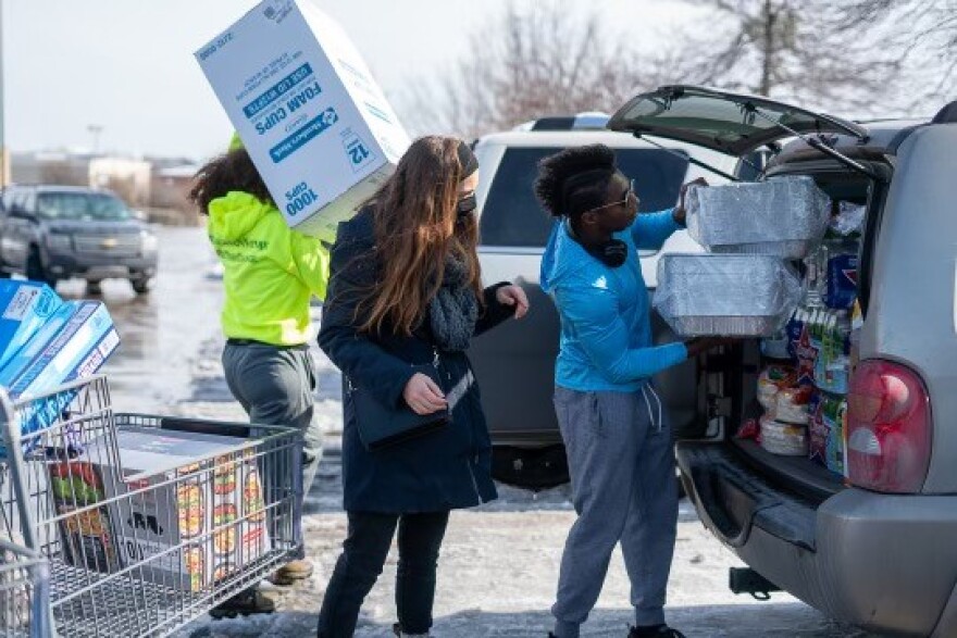 Volunteers with the coalition, Feed The People Dallas is are loading boxes food supplies into the a van to take to Borjas Cocina Mexican.