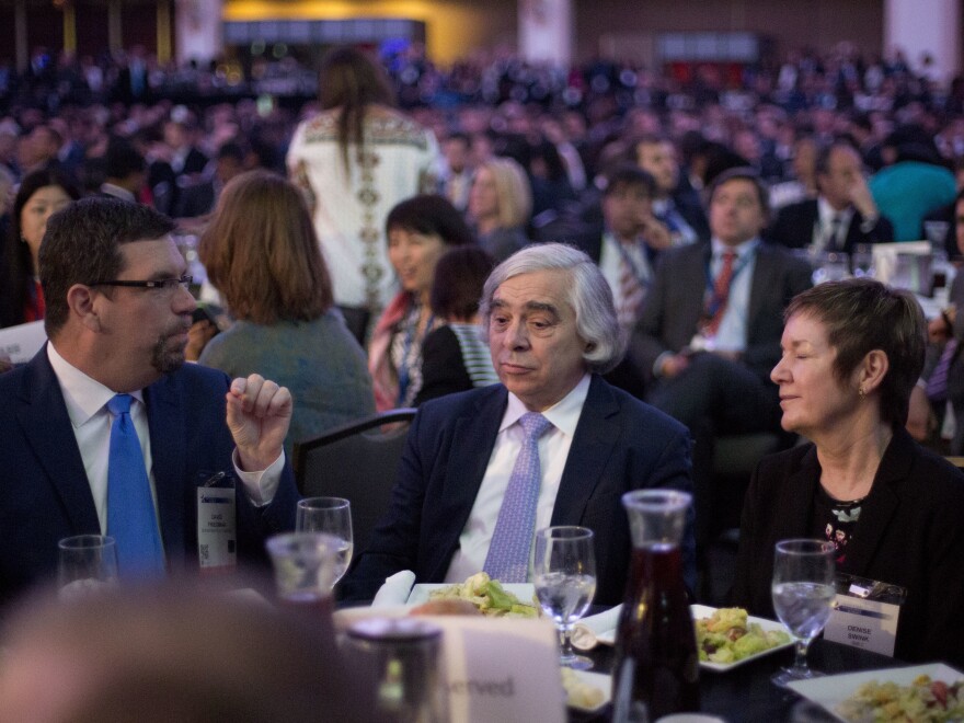 Energy Secretary Ernest Moniz (center) sits with other guests at the SelectUSA Investment Summit in Washington on Monday.