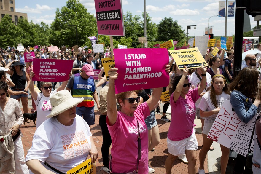 Abortion rights activists on Thursday gathered near the Gateway Arch to protest the potential closure of Missouri's only abortion provider. They marched to the Wainwright State Office Building and decried the state's efforts to limit access to abortion.