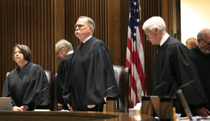 In this July 18, 2017 file photo, Chief Justice Lawton Nuss, third from left, lead justices to their seats to hear arguments on a school funding case before the Kansas Supreme Court in Topeka, Kan. The Court ruled Monday, Oct. 2, 2017, that legislators did not increase spending on the state's public schools enough this year, hinting in its opinion that lawmakers fell hundreds of millions of dollars short a year of providing a suitable education for every child. The court rejected the state's arguments that a new law phasing in a $293 million increase in funding over two years was enough to provide a suitable education for each of the state's 458,000 students. (Orlin Wagner, File/AP)