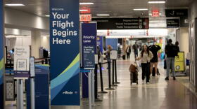 Passengers walk to their check-in desks at Boston's Logan Airport, Terminal B.  (Robin Lubbock/WBUR)