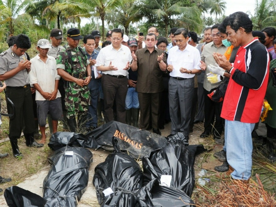 Indonesian officials pray over the bodies of tsunami victims on North Pagai island, one of the Mentawai islands, on Wednesday.