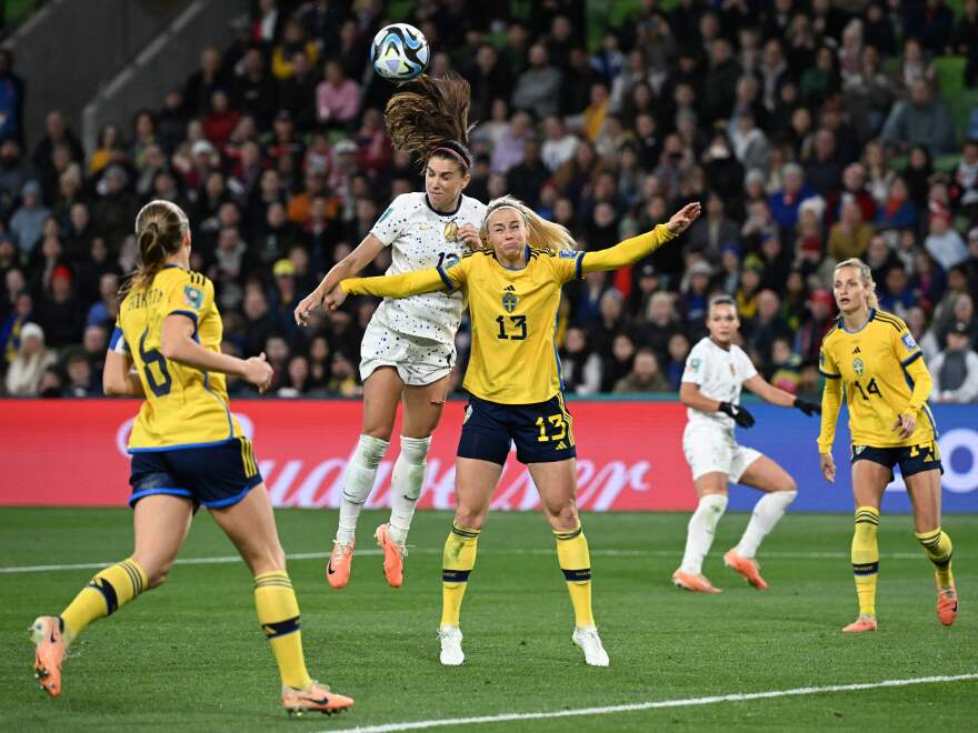 USA forward Alex Morgan (C) heads the ball next to Sweden's defender Amanda Ilestedt in the 89th minute of their Women's World Cup matchup on August 6, 2023.