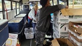The Children's Table volunteers prepare for mobile food distributions on the rural food bank bus.