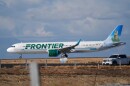 A Frontier Airlines jetliner taxis down a runway for take off from Denver International airport on Nov. 25, 2025, in Denver.