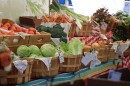 A mix io vegrtaves like lettuce and tomatoes in baskets.
