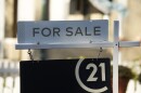 A for sale sign stands outside a single-family home on the market late Friday, Oct. 27, 2023, in Denver.