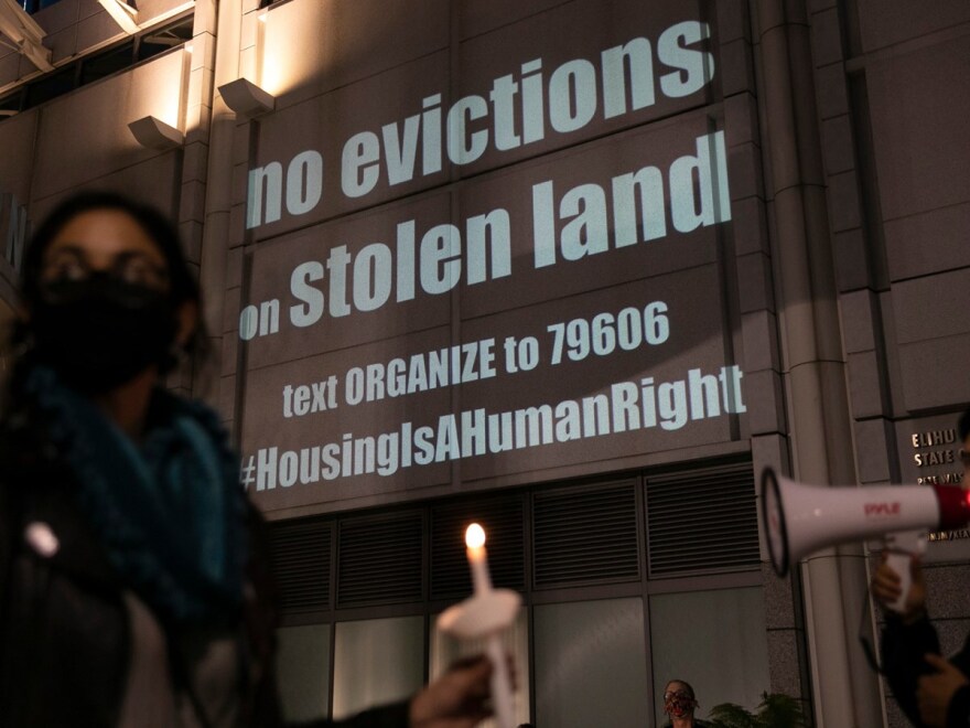 Housing activists and rent strikers participate in a vigil for tenants who they say will not be covered by Gov. Gavin Newsom’s rent relief plan at the Elihu M. Harris, State of California office building in Oakland on Jan. 29, 2021.