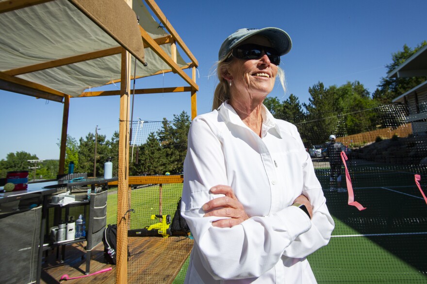 Heather Glass observes a pickleball tournament on her property.