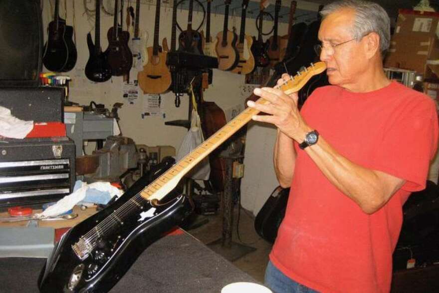 Mike Acosta checking the neck of a Fender Stratocaster