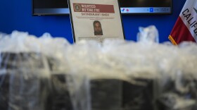 An FBI Wanted poster for Satinderjeet Singh is displayed at a news conference at the Federal Building in Los Angeles, Tuesday, July 7, 2026.