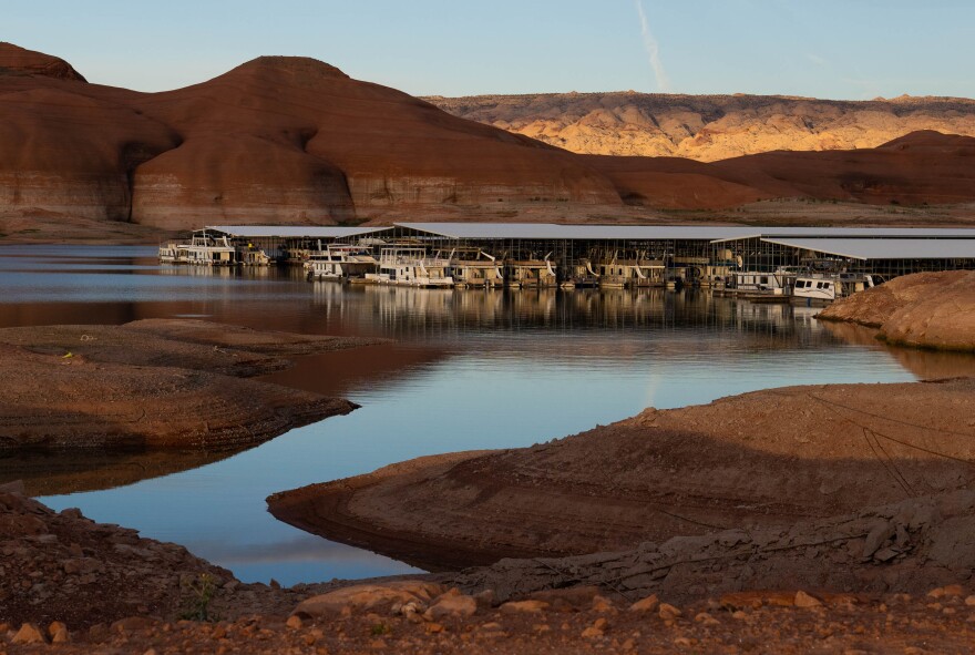 House boats parked in a line in a large body of water.