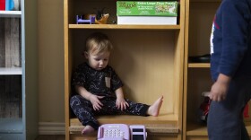A child sits in a bookshelf at Kid's Castle Family Daycare and Preschool in Pflugerville in 2022.