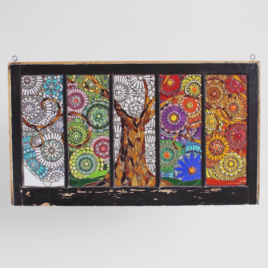 A mosaic piece representing the four seasons with a tree in the middle.