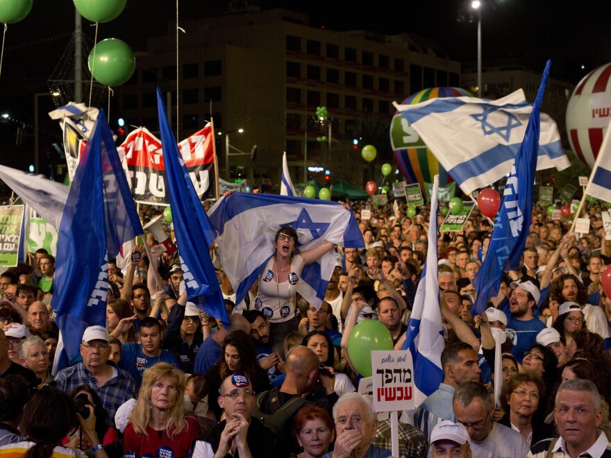 People shout slogans during a rally in Rabin's square in Tel Aviv, Israel, late Saturday.