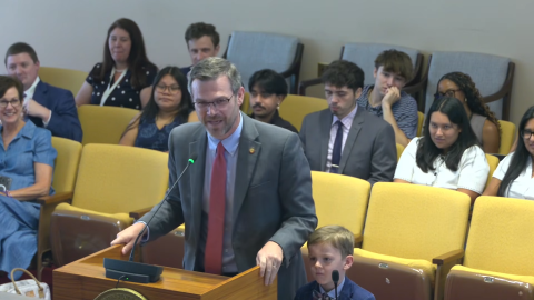 Rep. Mike Schietzelt, R-Wake, was joined by his son as he presented a proposed sales tax exemption on diapers and feminine hygiene products to the House Rules Committee.
