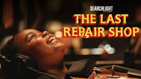 Young African America girl holding violin smiles in excitement in the documentary The Last Repair Shop