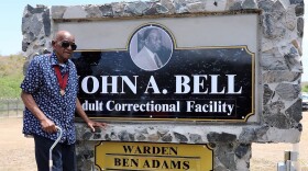 Pictured: Former Senator John A. Bell stands beside the newly unveiled sign for the John A. Bell Adult Correctional Facility during the official renaming ceremony in 2022.
