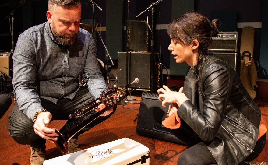 Trumpeter Matt Cappy shows the Instrument of Hope to World Café host Talia Schlanger.