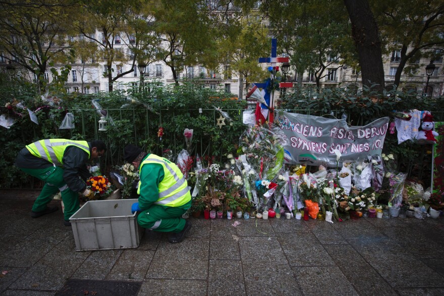 Drawings, messages, photographs, flowers or teddy bears, like these items being collected by city agents, will be stocked in the Paris city hall's archives as a testament to the events of November 13.