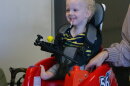 A small child tries out a new mobility device.