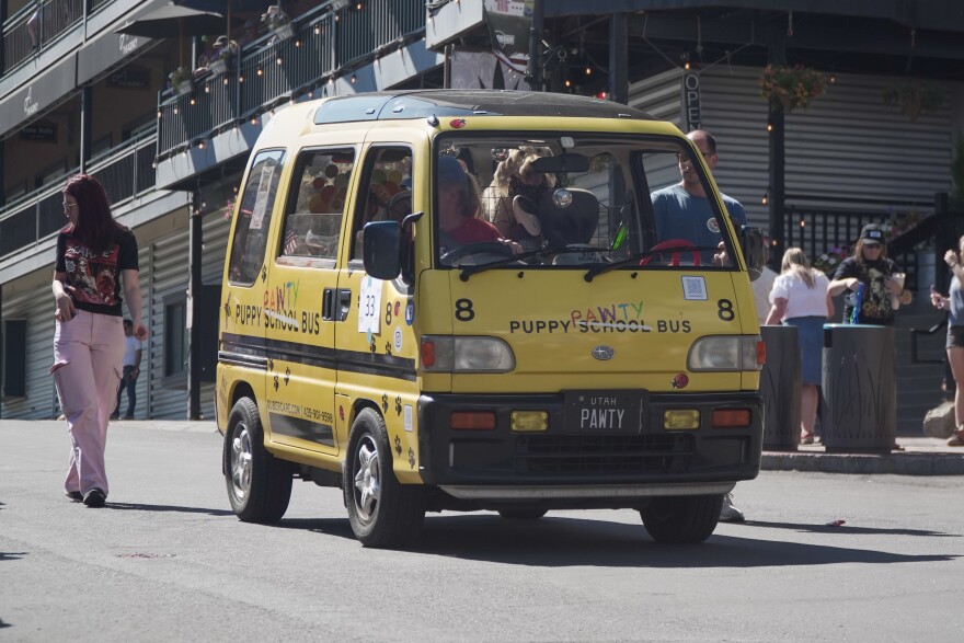 The Puppy Pawty Bus drives down Main Street during the 2025 Miners Day parade.