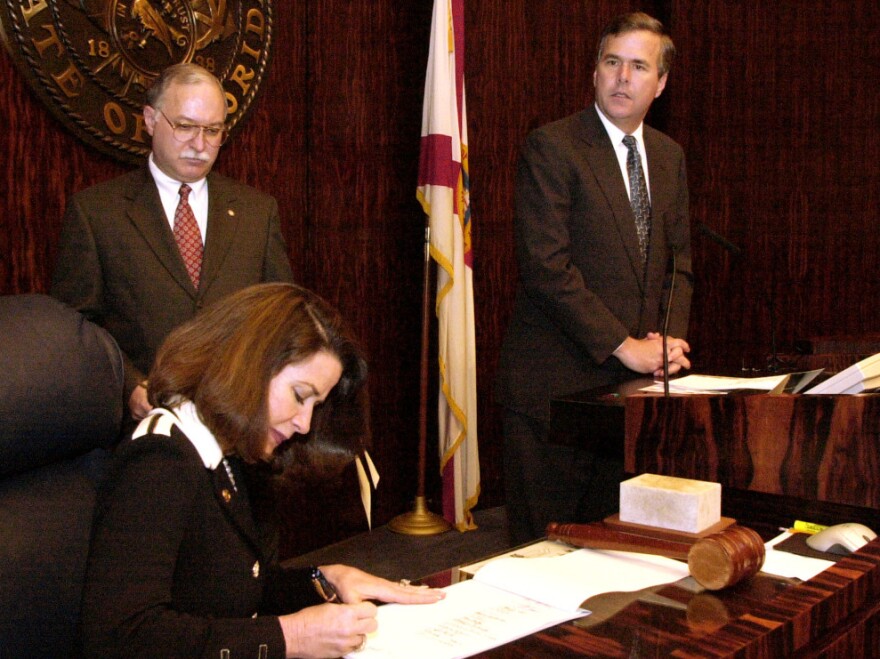 Florida Secretary of State Katherine Harris signs the final certification of the state's electoral votes to Republican George W. Bush on Dec. 18, 2000, in Tallahassee.