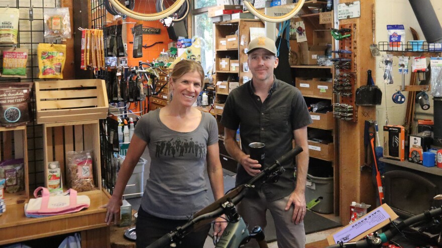 Sue and Eugene Cathcart, co-owners and partners at Oakridge's Willamette Mountain Mercantile stand near the front of their store in this July 13, 2026 photo.